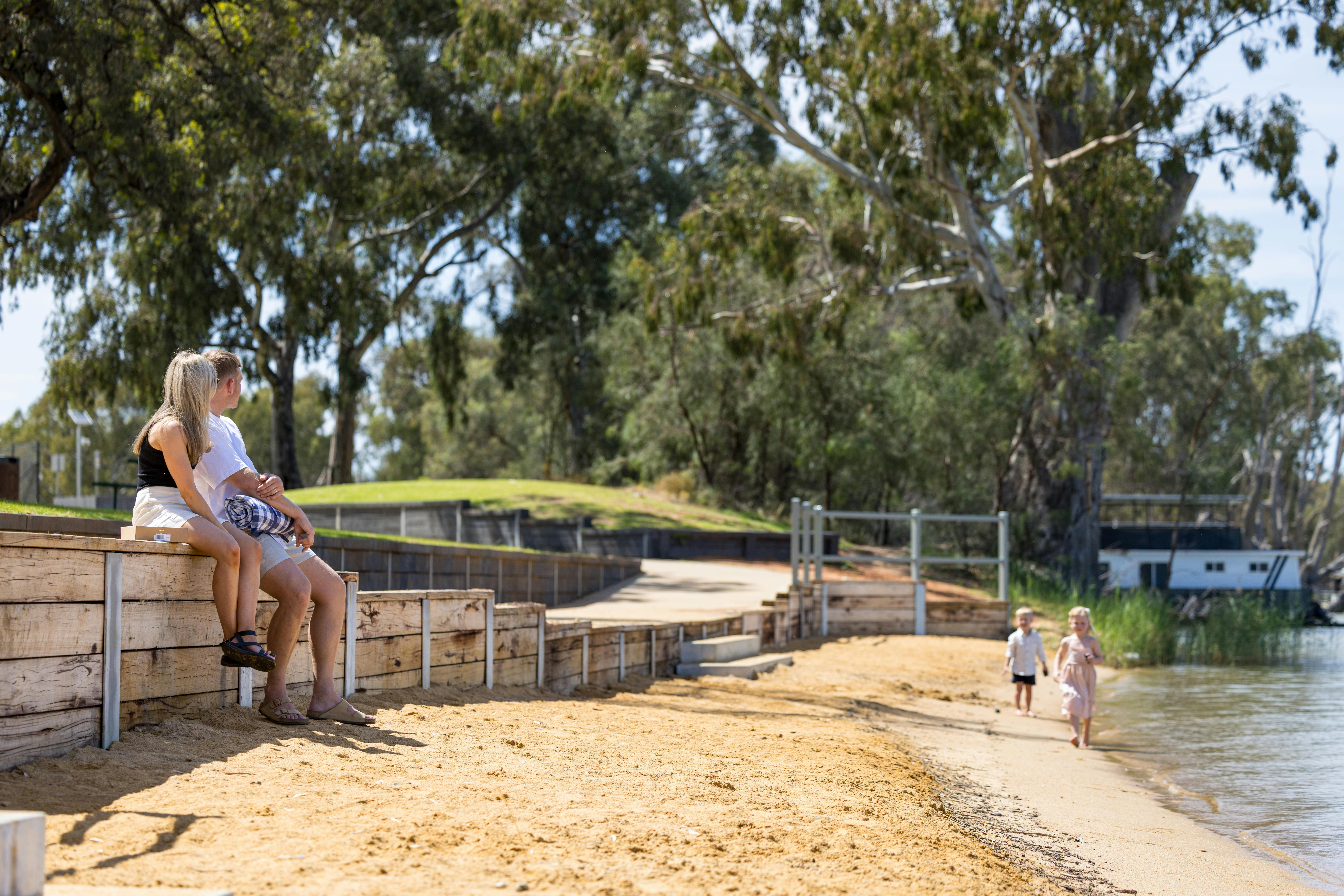 Mum and Dad watching children on Riverbank
