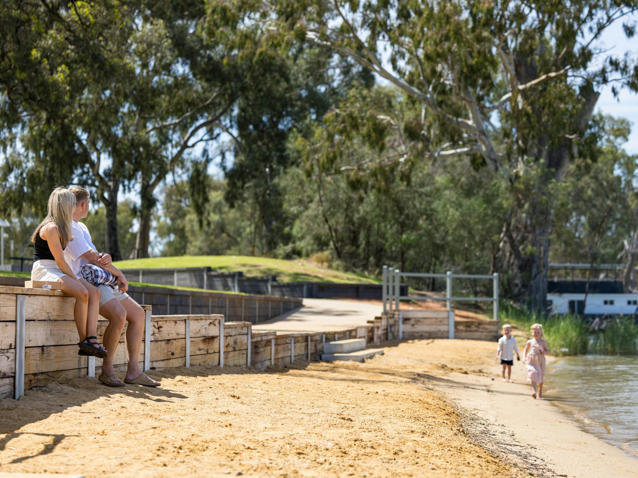 Mum and Dad watching children on Riverbank