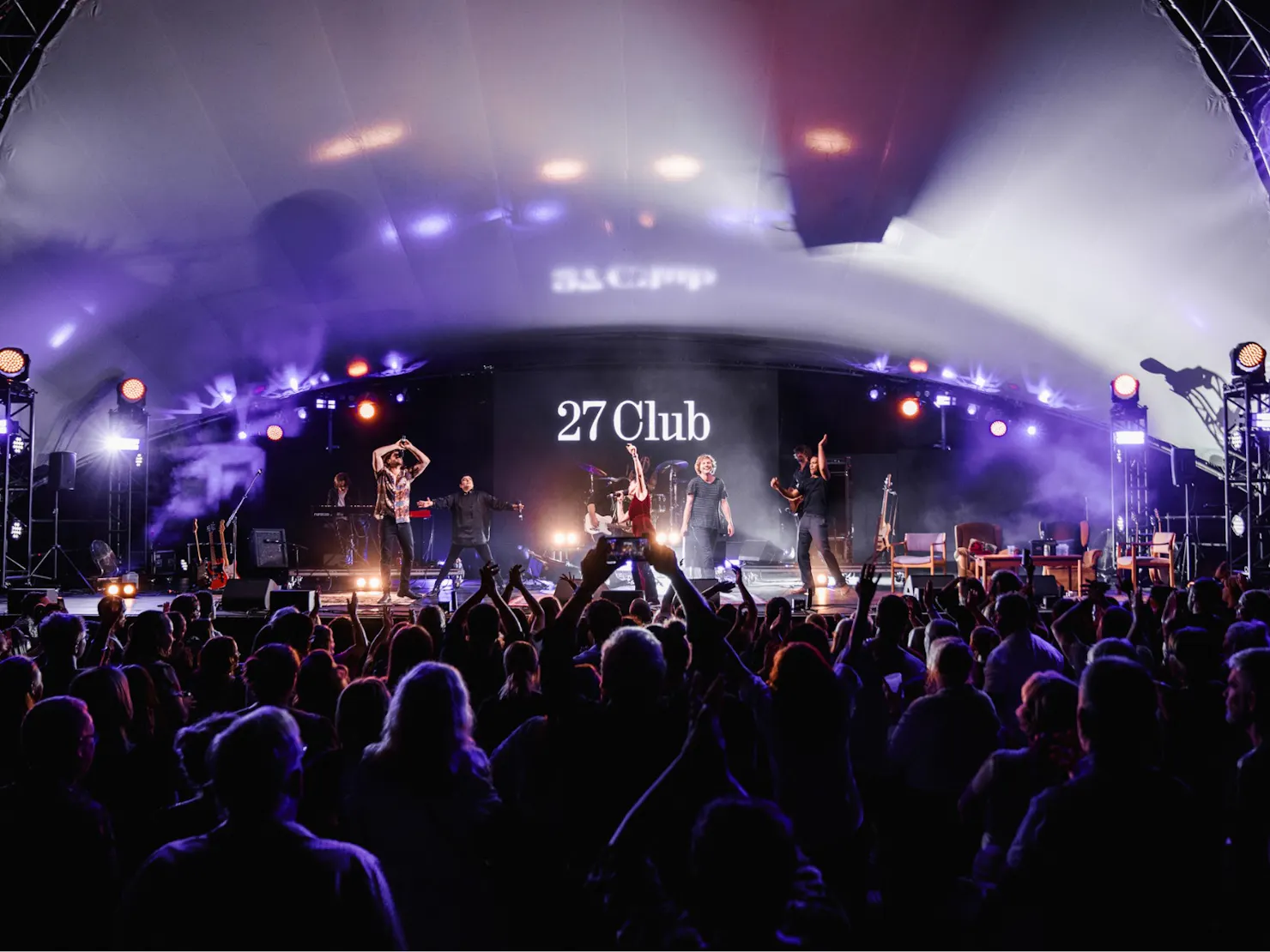 A photo from the the crowd perspective of the stage at night.