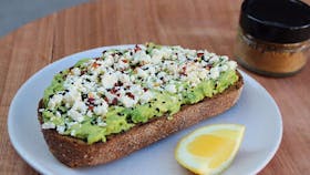 Avocado on toast with feta cheese and lemon
