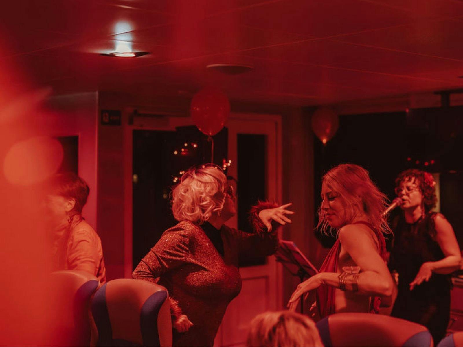 People dancing on Strahan Solstice Cruise with World Heritage Cruises.