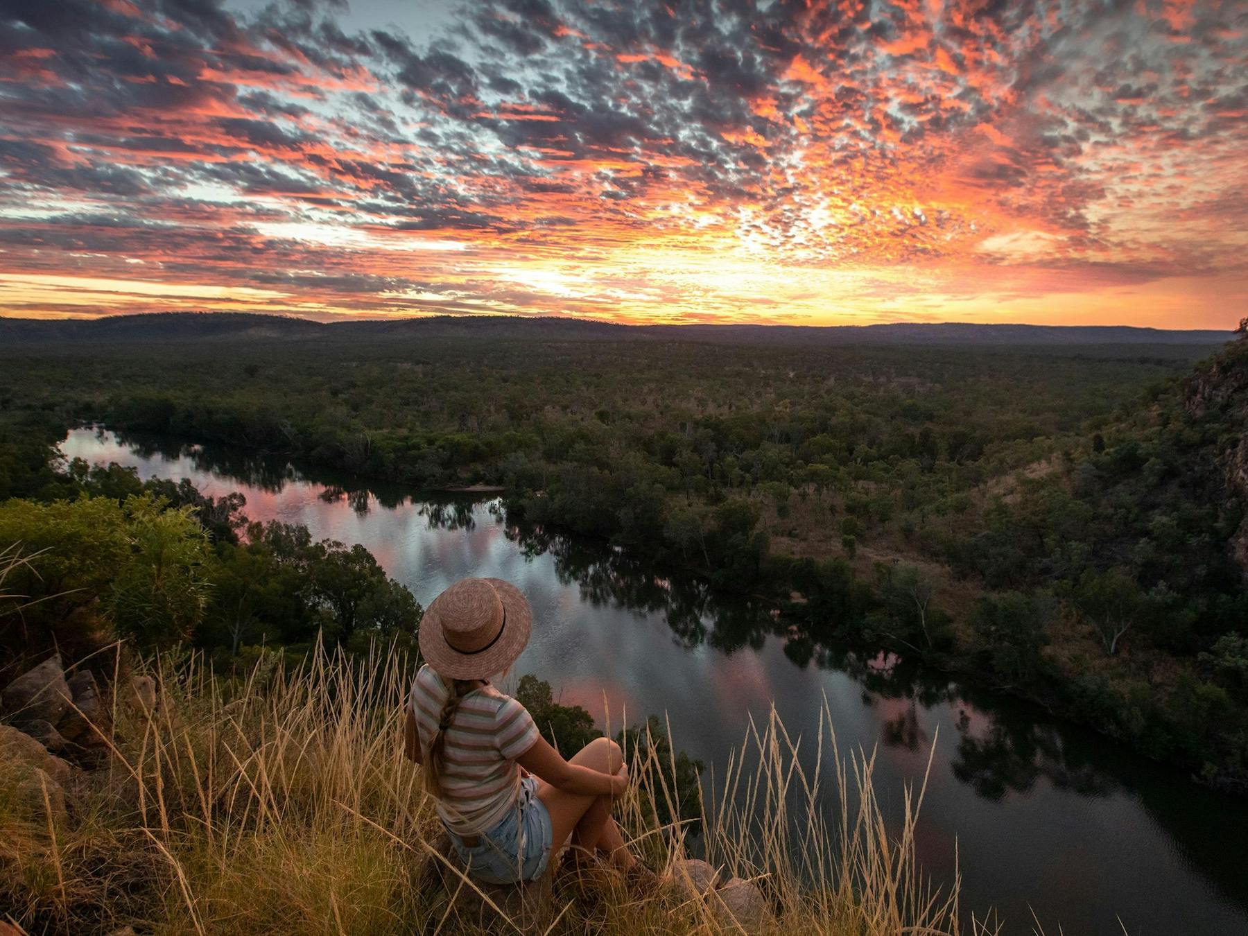 Girl watching the sunset from a hill over Nitmiluk National Park