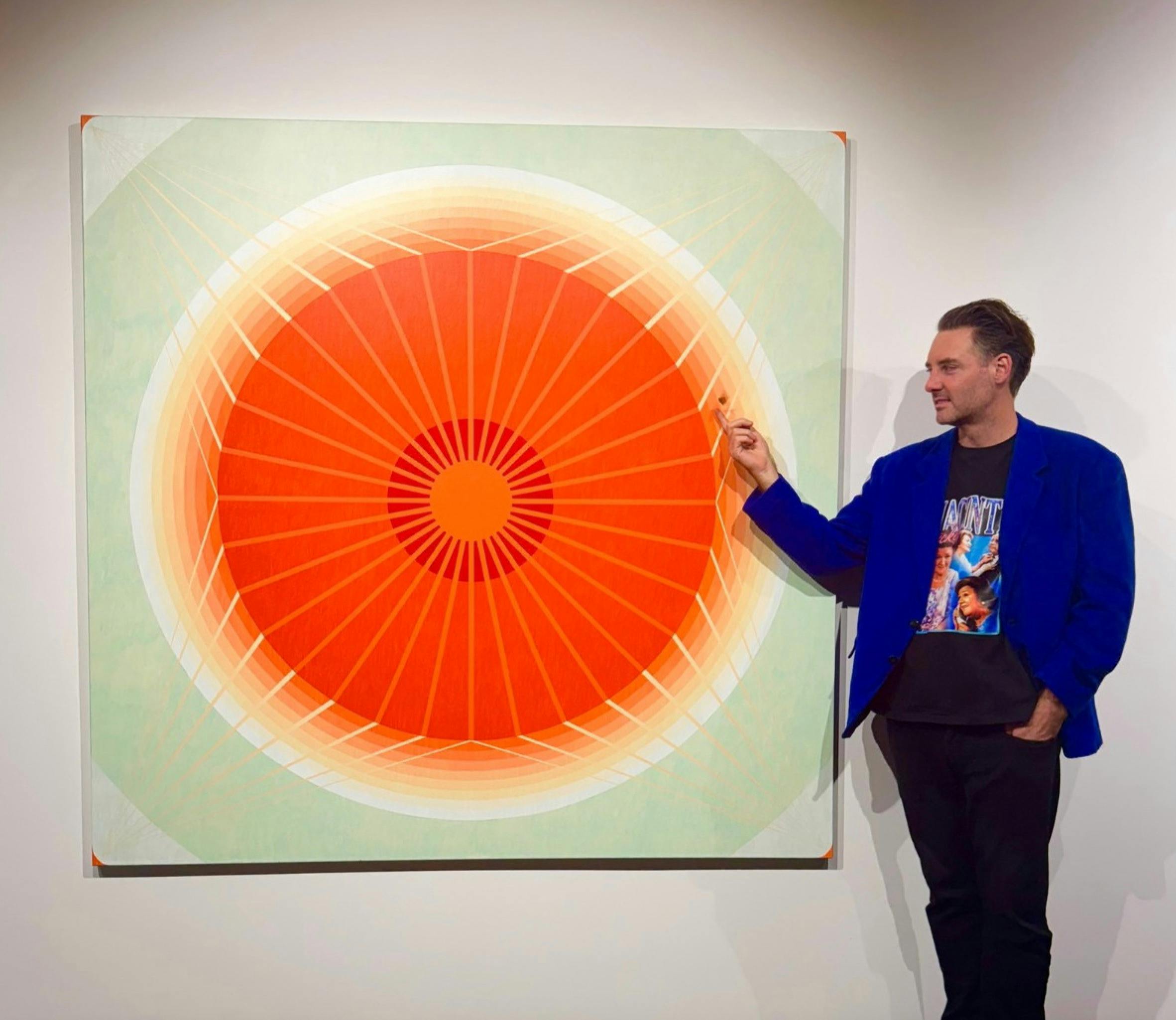 Artist Andy Harwood standing next to one of his artworks