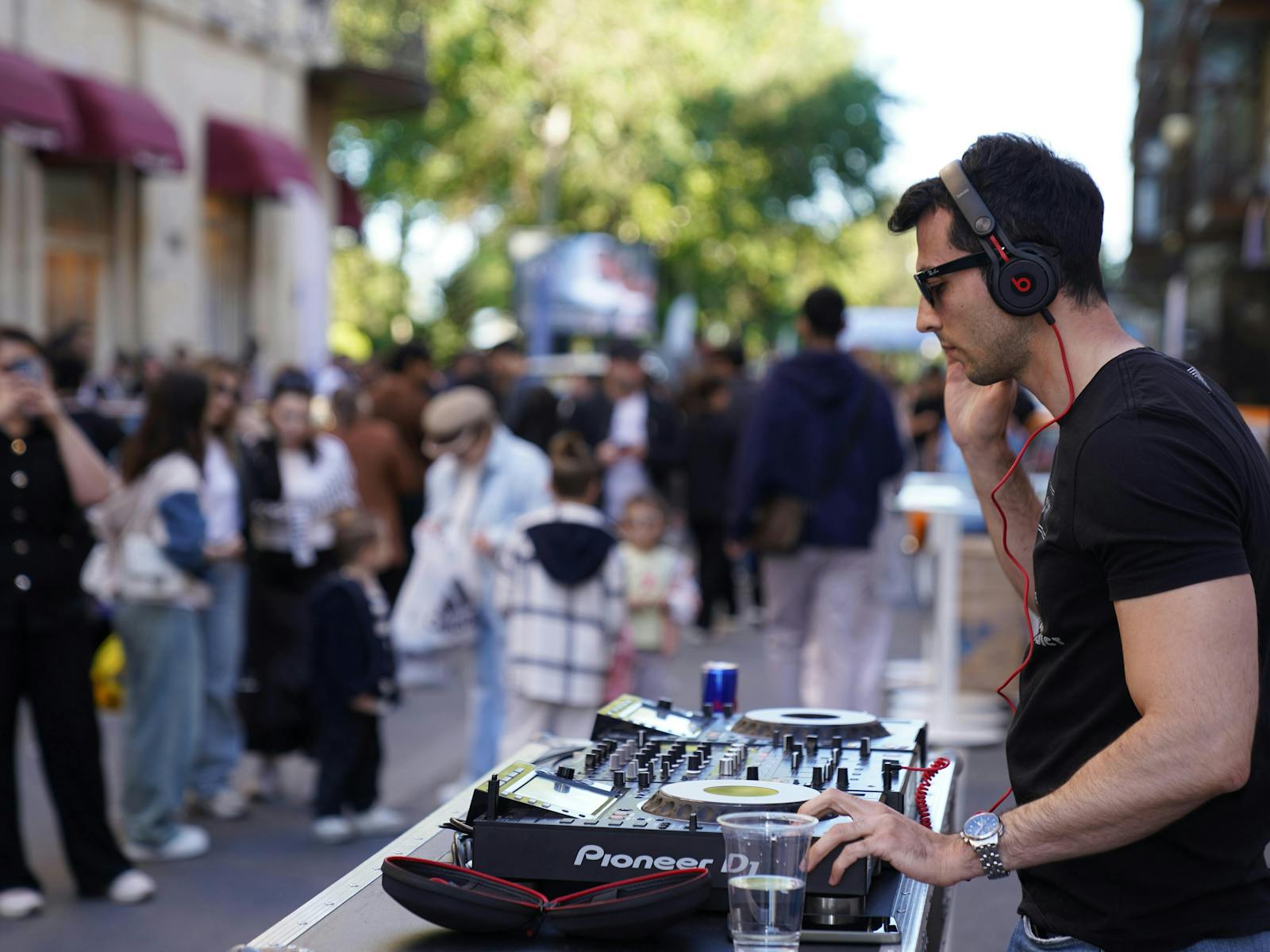Street party visitors listen to a DJ