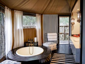 The King Deluxe tent has an internal bathroom with plunge bath and double sink vanity