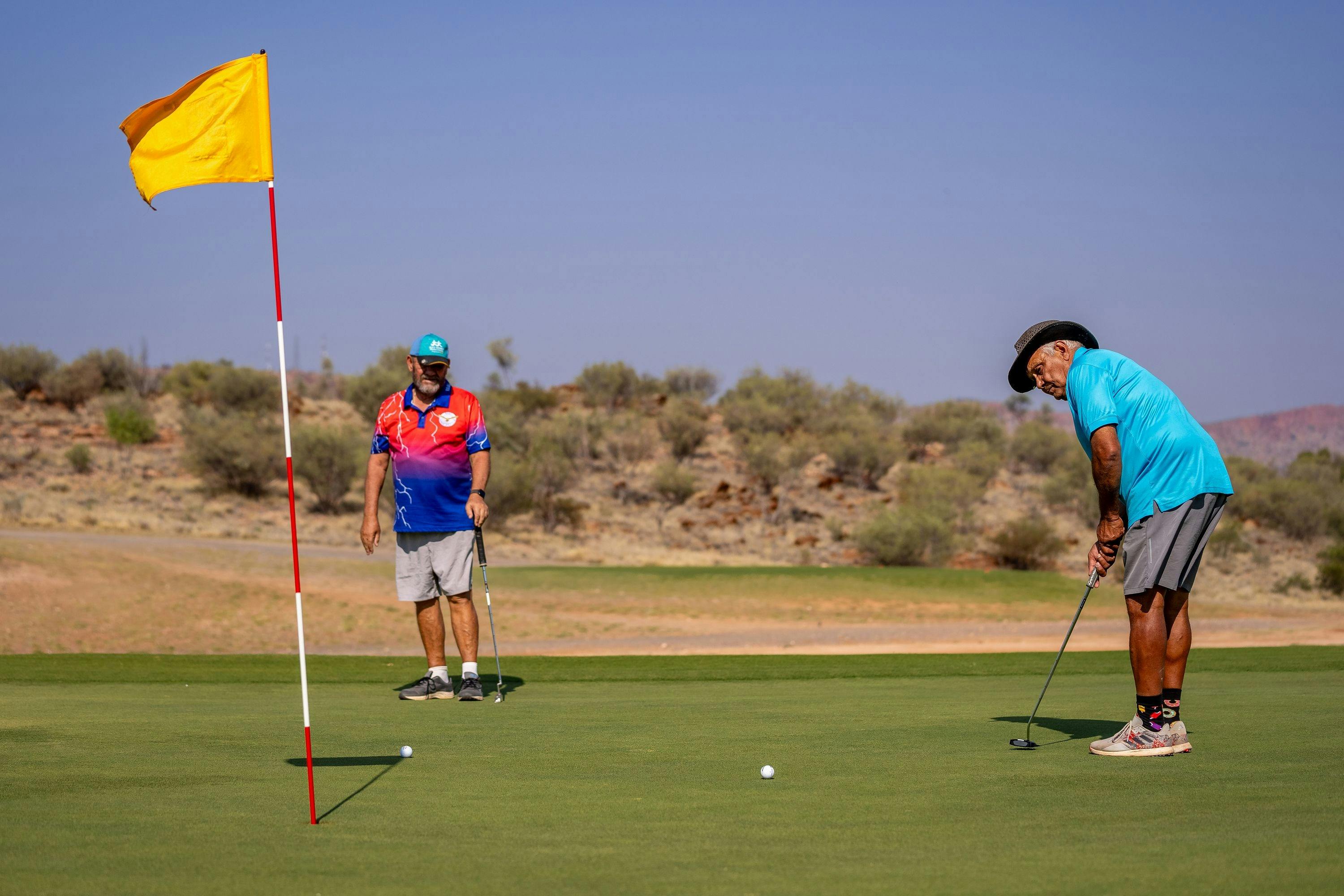 Two men playing golf