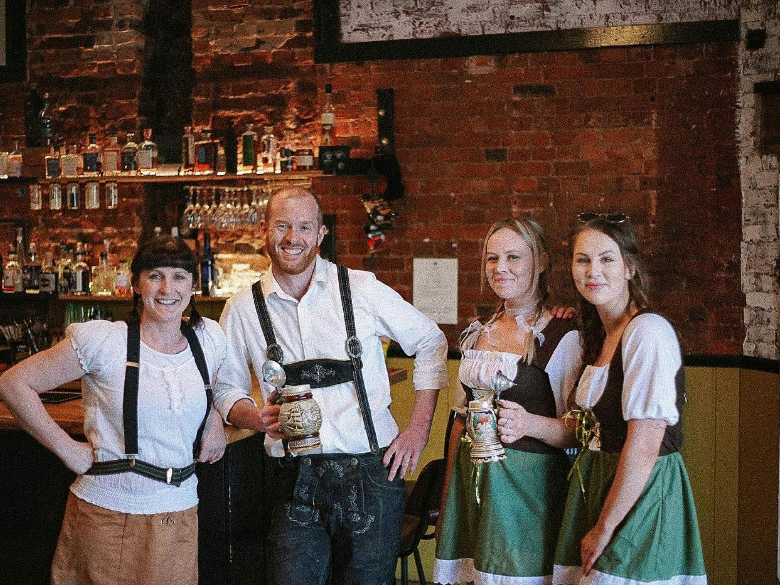 4 of our staff wearing lederhosen for our Oktoberfest.