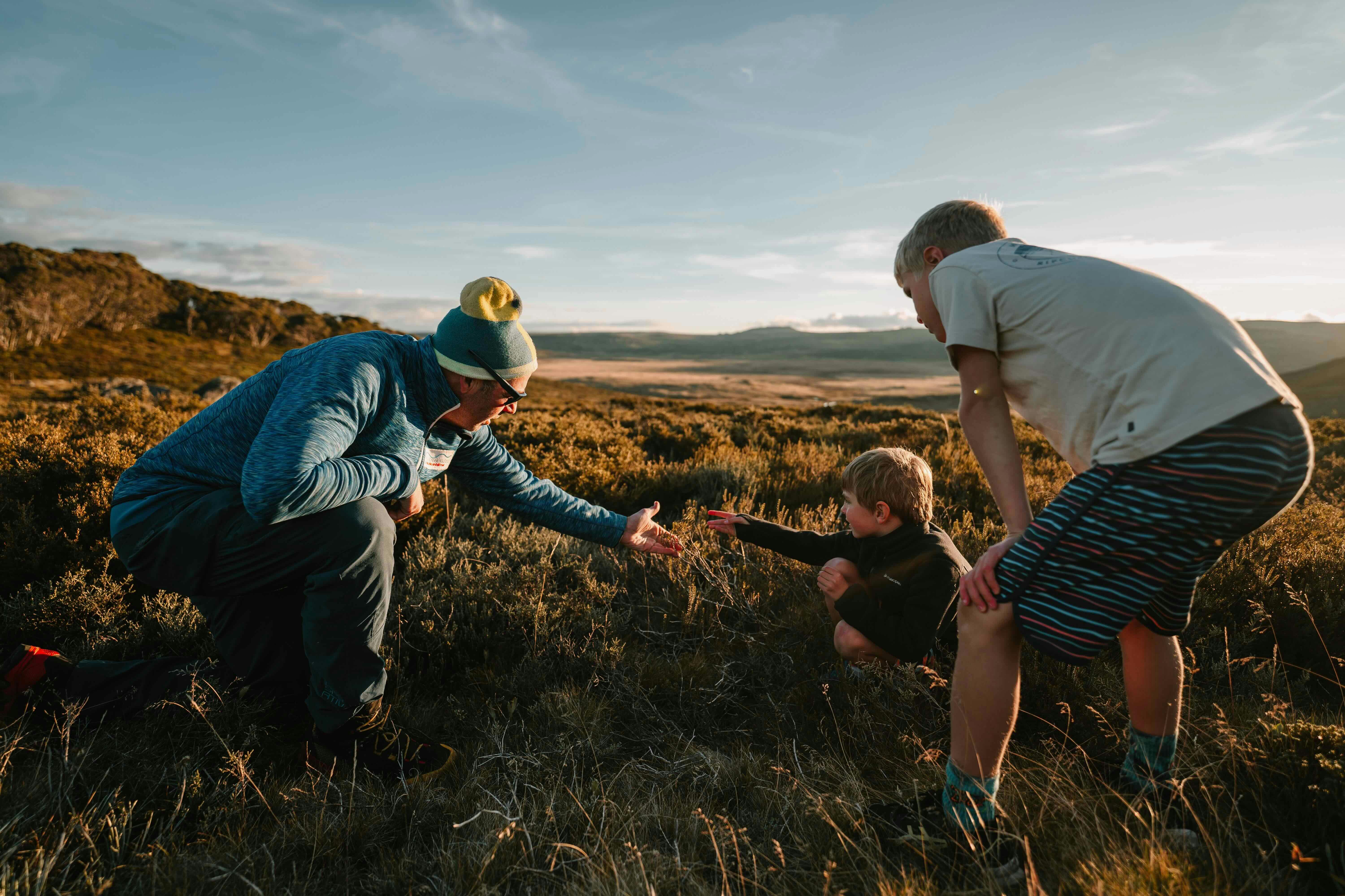 A man and two boys outdoors