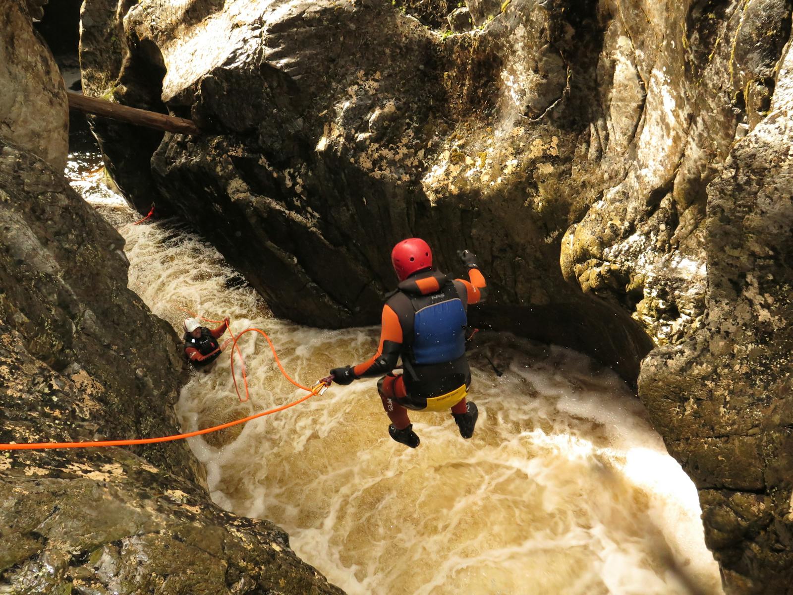 Canyoning at Cradle Mountain. Jumping off Tea Cup Falls in Dove Canyon.