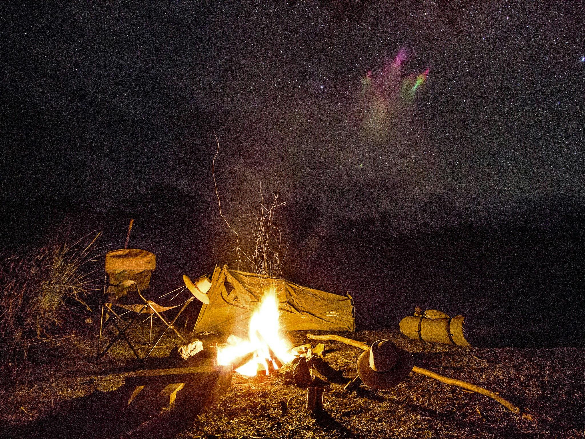 Campfire and camp at night.