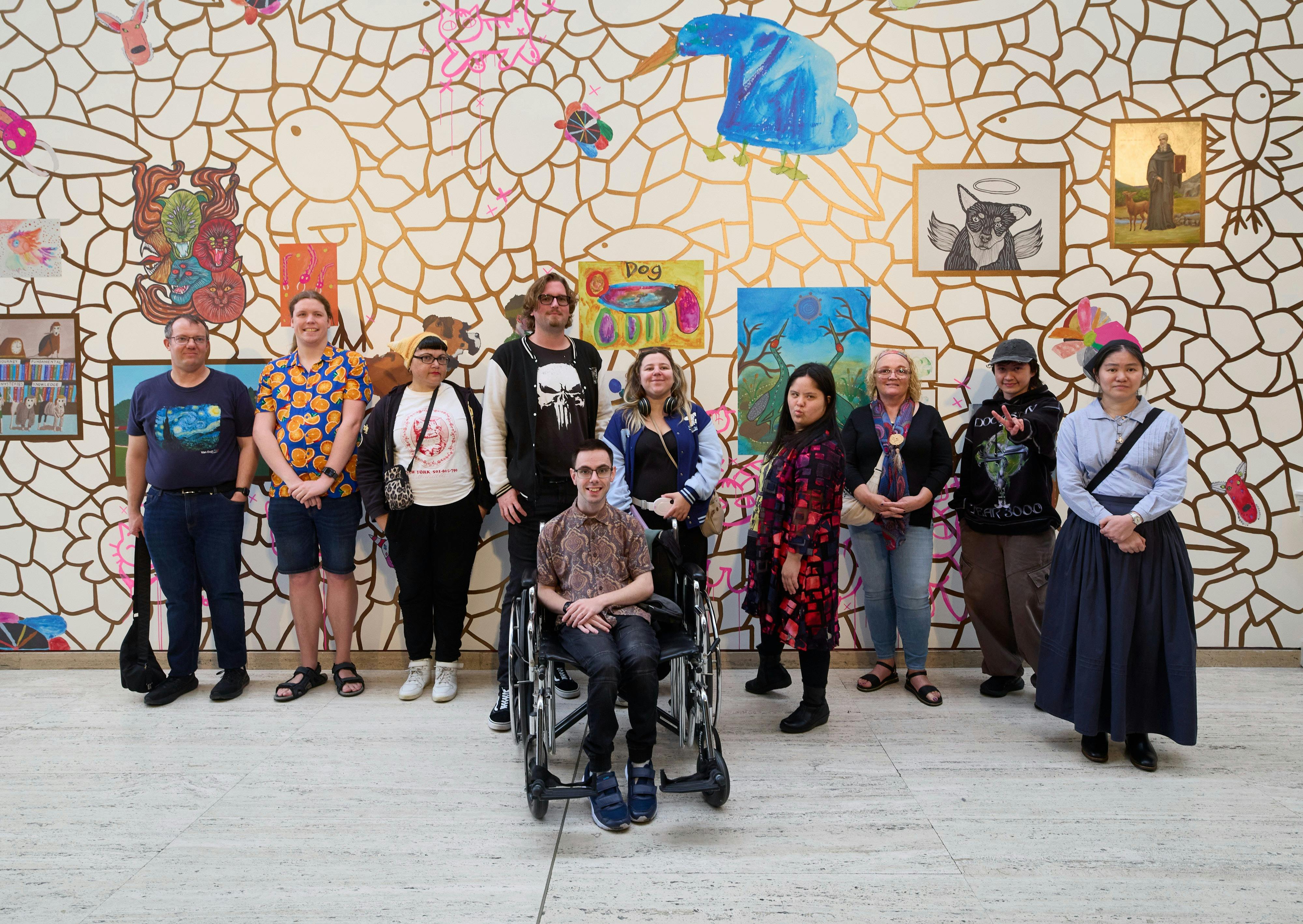Photograph of Little Orange artists in front of their Pet Palace mural at the Art Gallery of NSW
