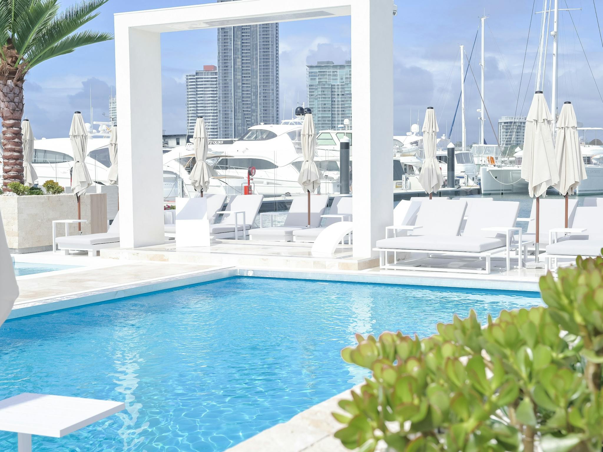 Waterfront atmosphere at La Luna Beach Club with sun lounges, umbrellas and harbour views Waterfront atmosphere at La Luna Beach Club with sun lounges, umbrellas and harbour views