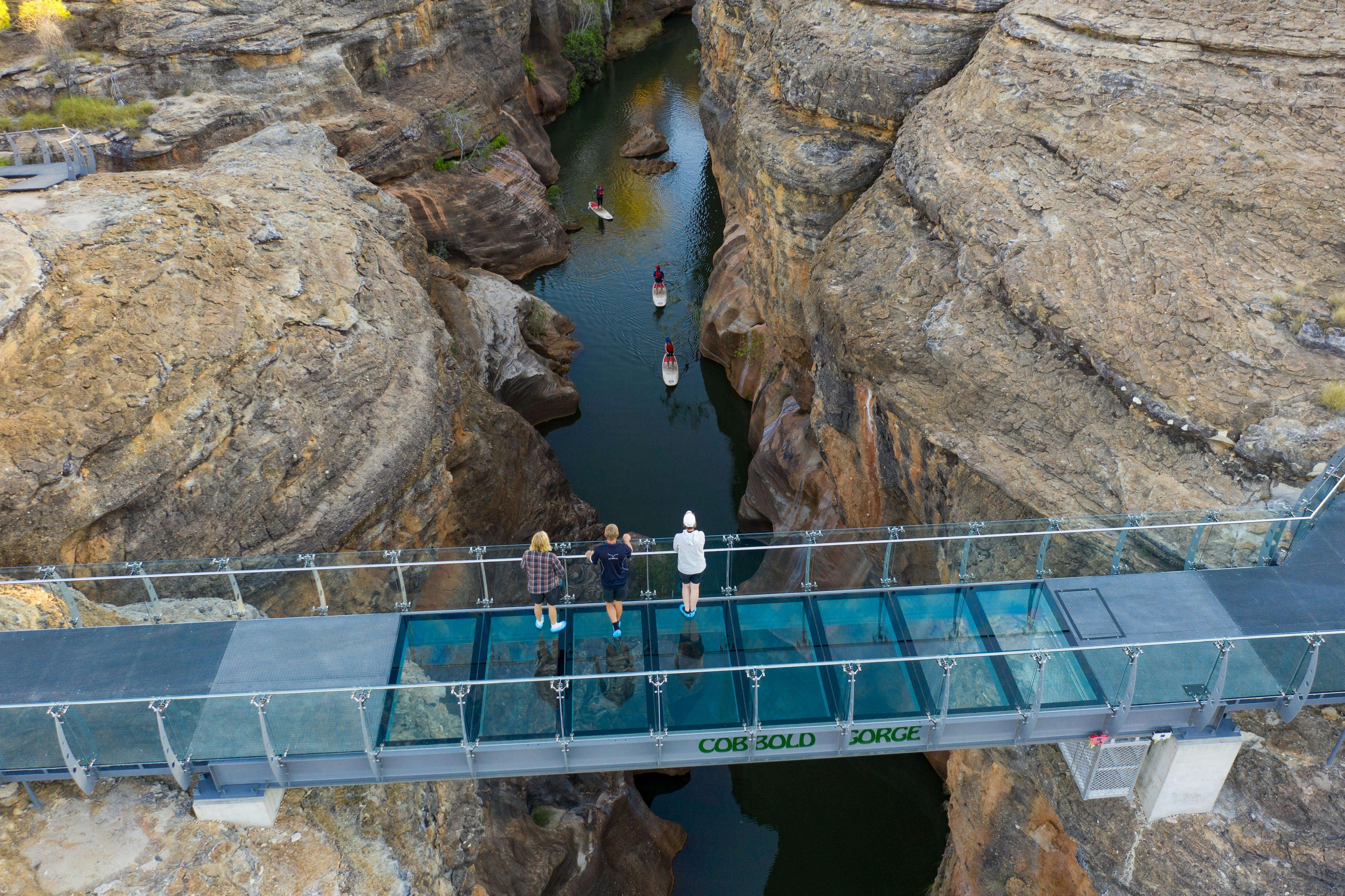 View from glass bridge into Cobbold Gorge, watching SUP boarders