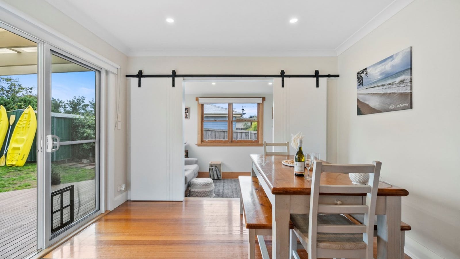 Large Dining, table off to sun room with office and large Television