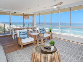 Open plan living room with beachfront views