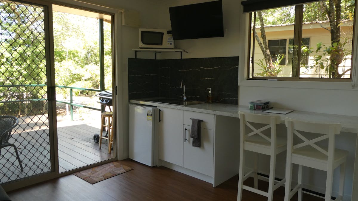 Fully equipped kitchenette in the rainforest cabins opening onto the out side deck with a gas BBQ