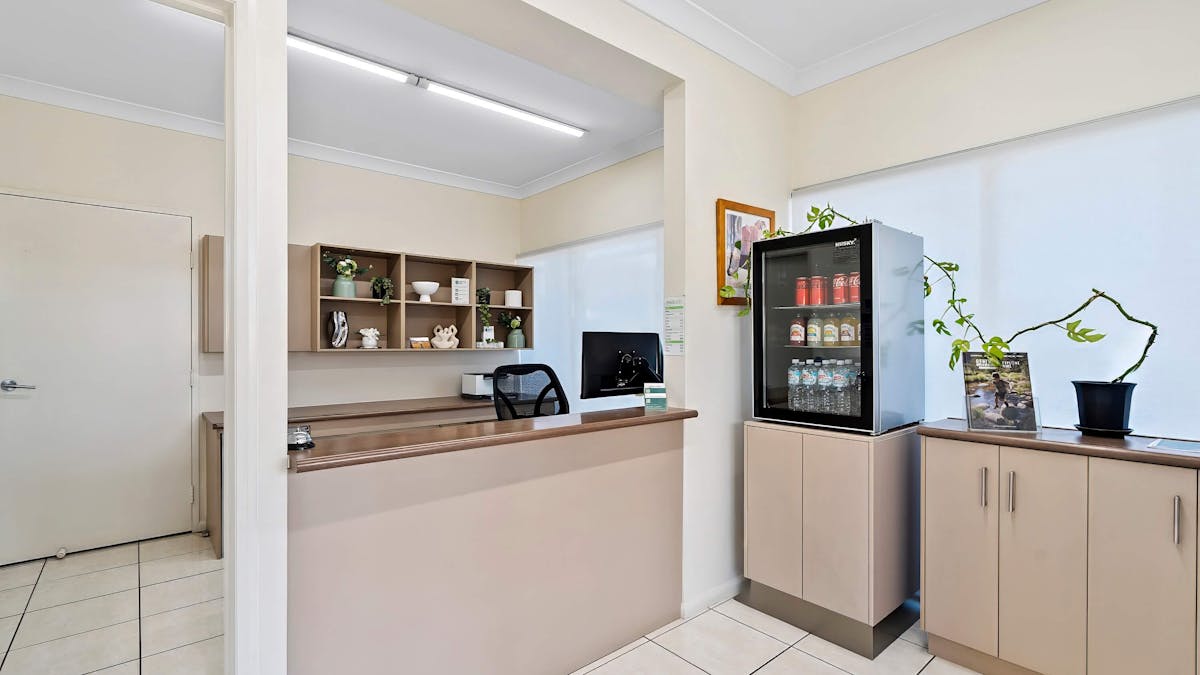 The welcoming reception area at the Emerald Inn featuring a drinks fridge for guest convenience.