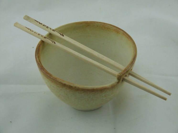 Brown bowl with two chopsticks