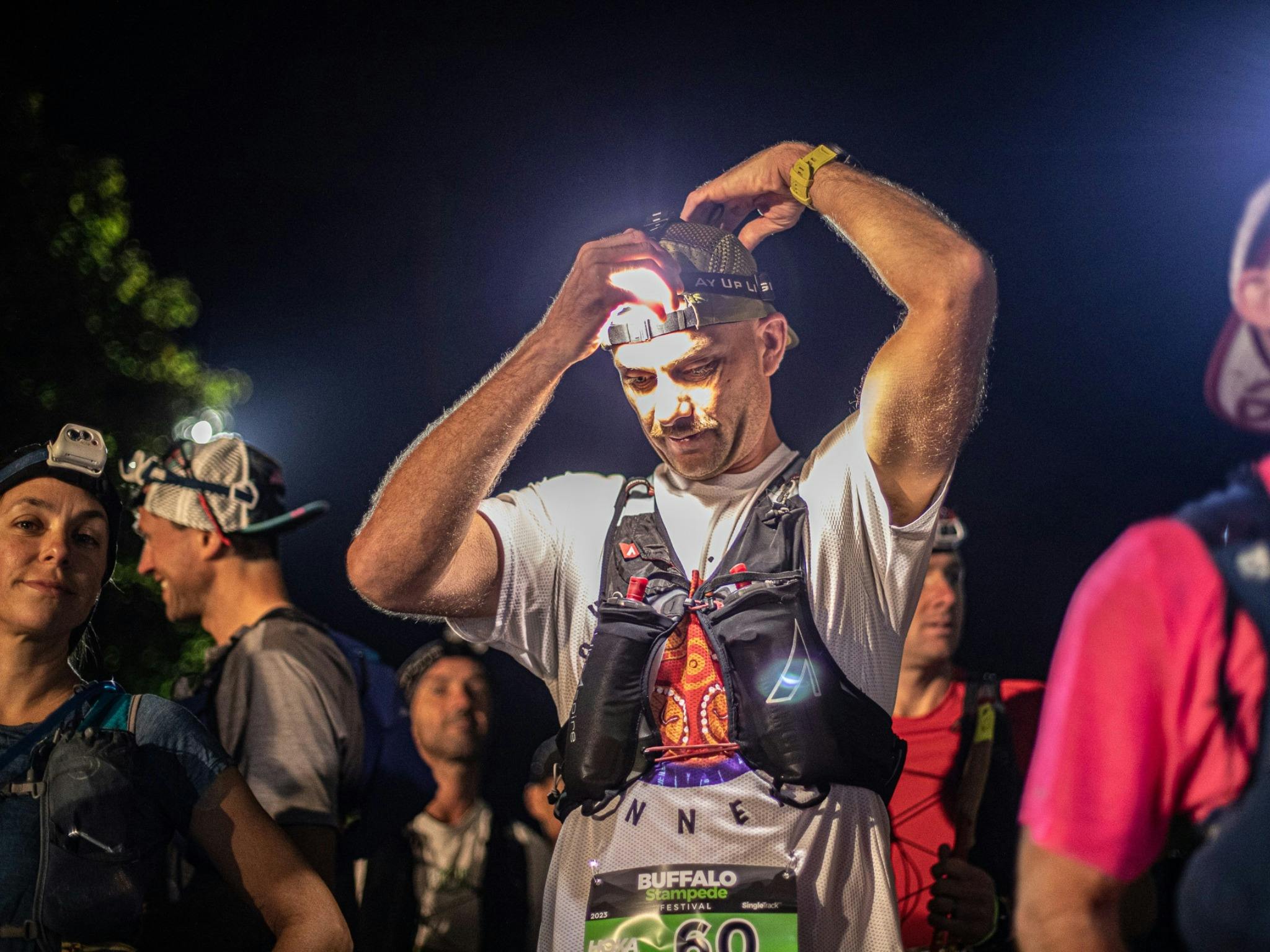 Man putting on headlamp.