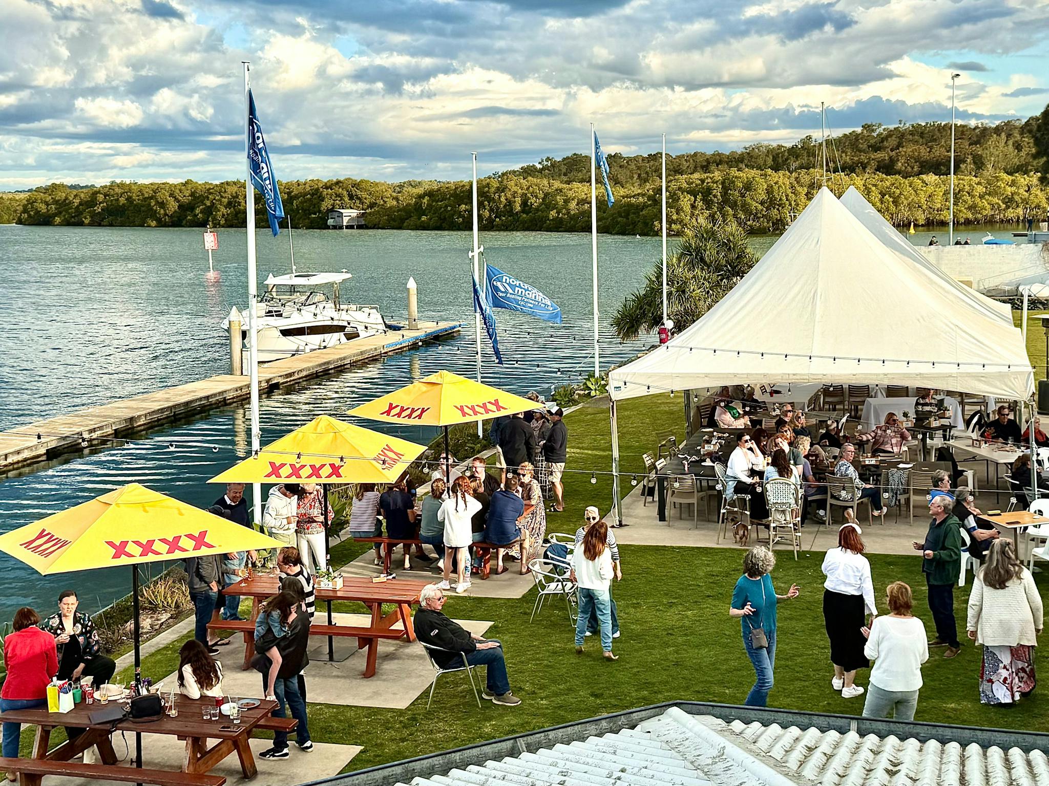 Diners sitting underneath umbrellas and Marquee enjoying water views over the Marina. Diners sitting underneath umbrellas and Marquee enjoying water views over the Marina.