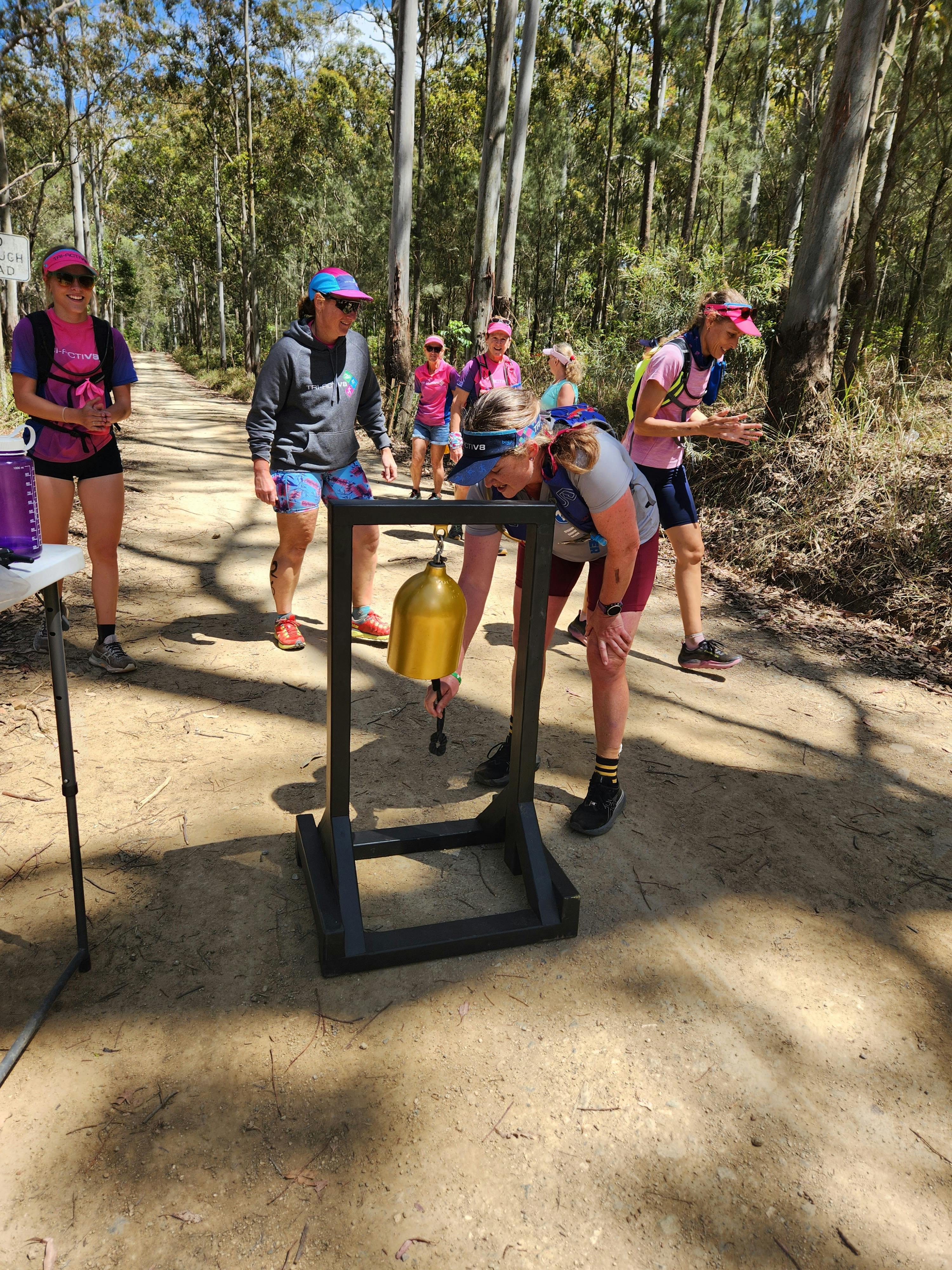 Trail runner ringing the gong