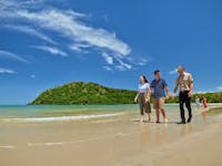 Two people and the tour guide walking on Cape Tribulation beach.