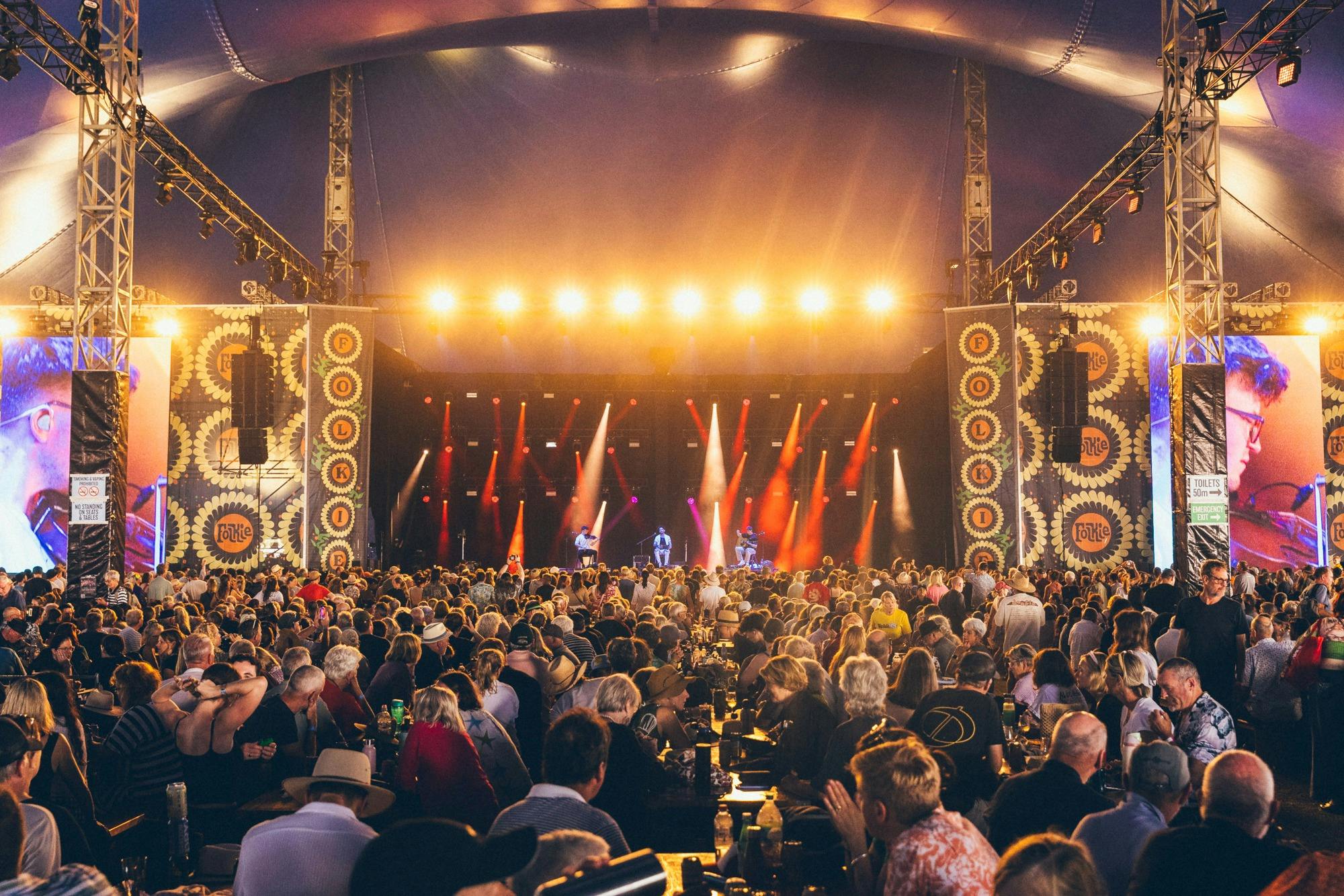 Large crowd watching artists on stage four