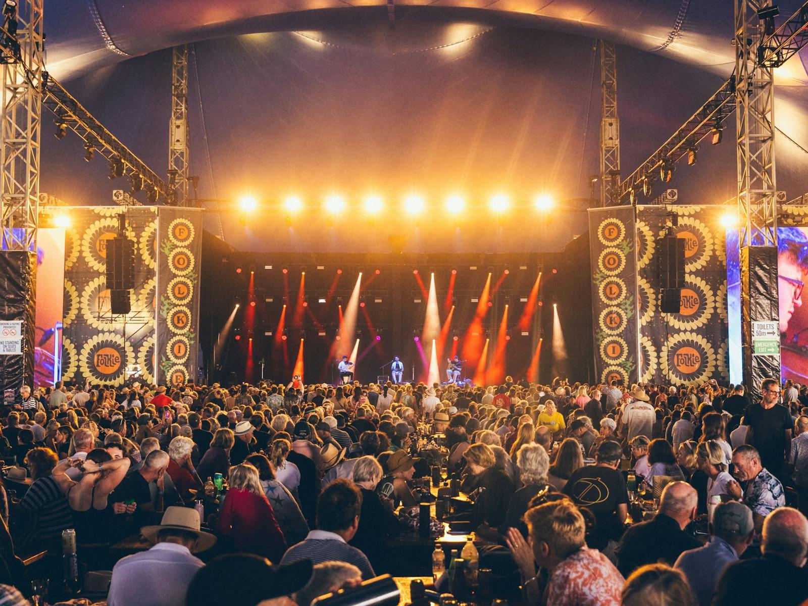 Large crowd watching artists on stage four