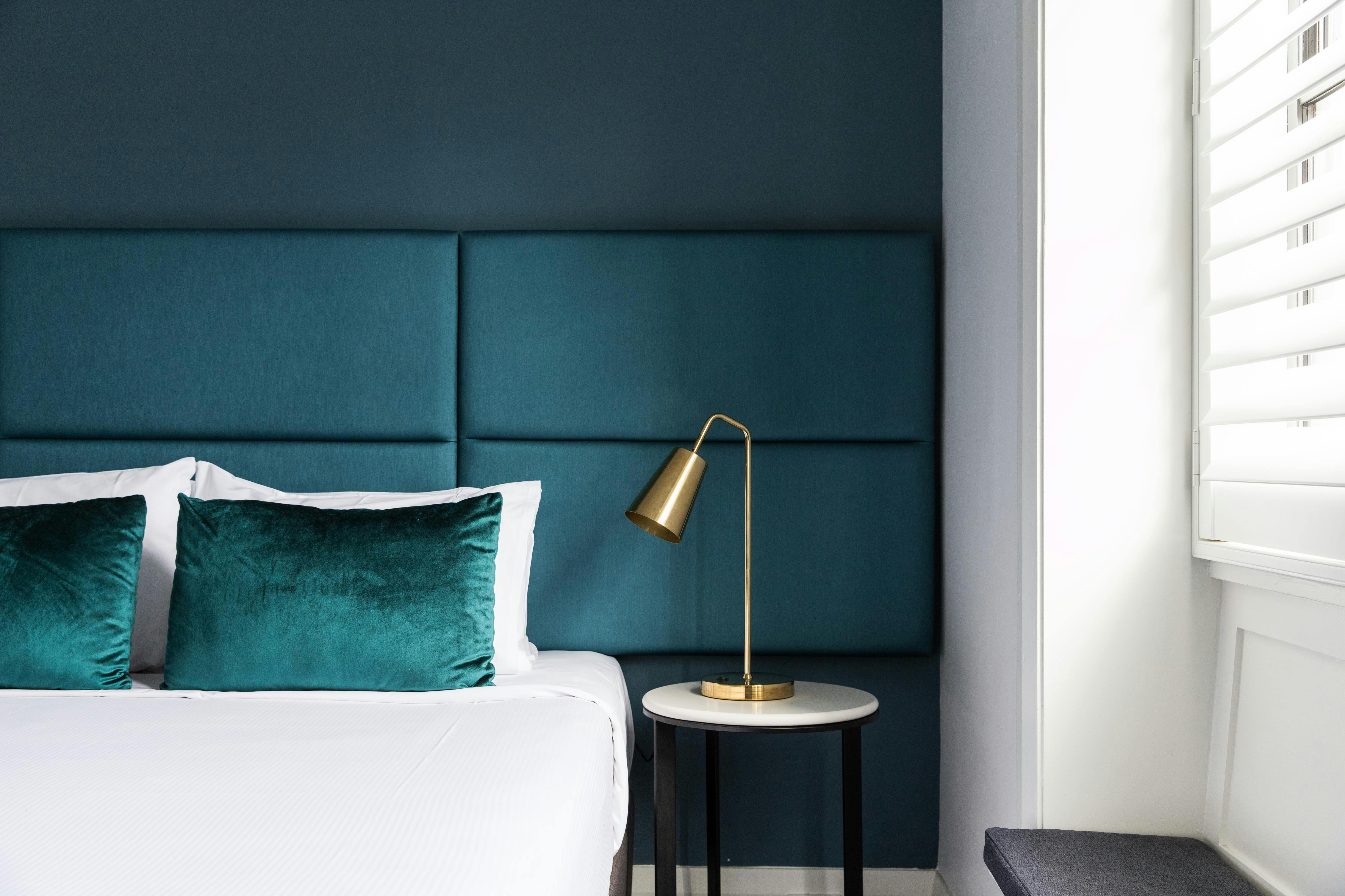 Beautiful green decor with bedside lamp and wide window