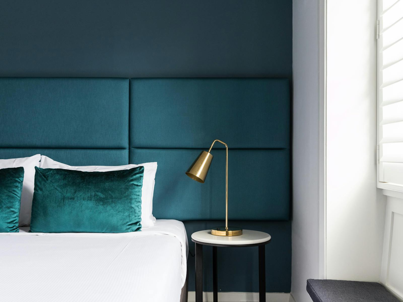 Beautiful green decor with bedside lamp and wide window