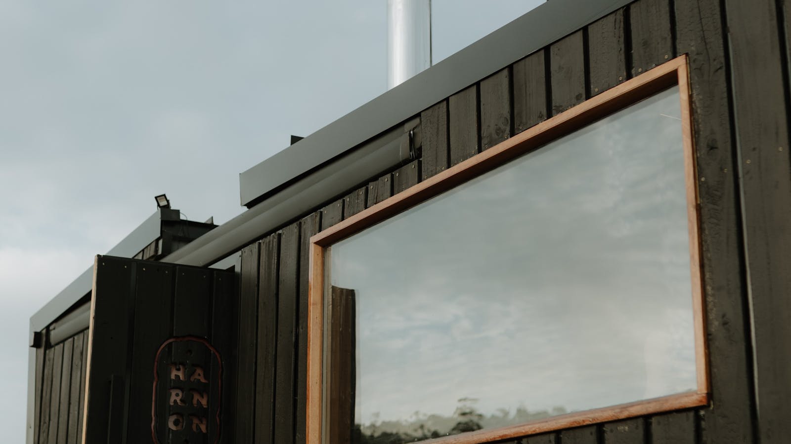 Handcrafted mobile sauna with panoramic viewing window.