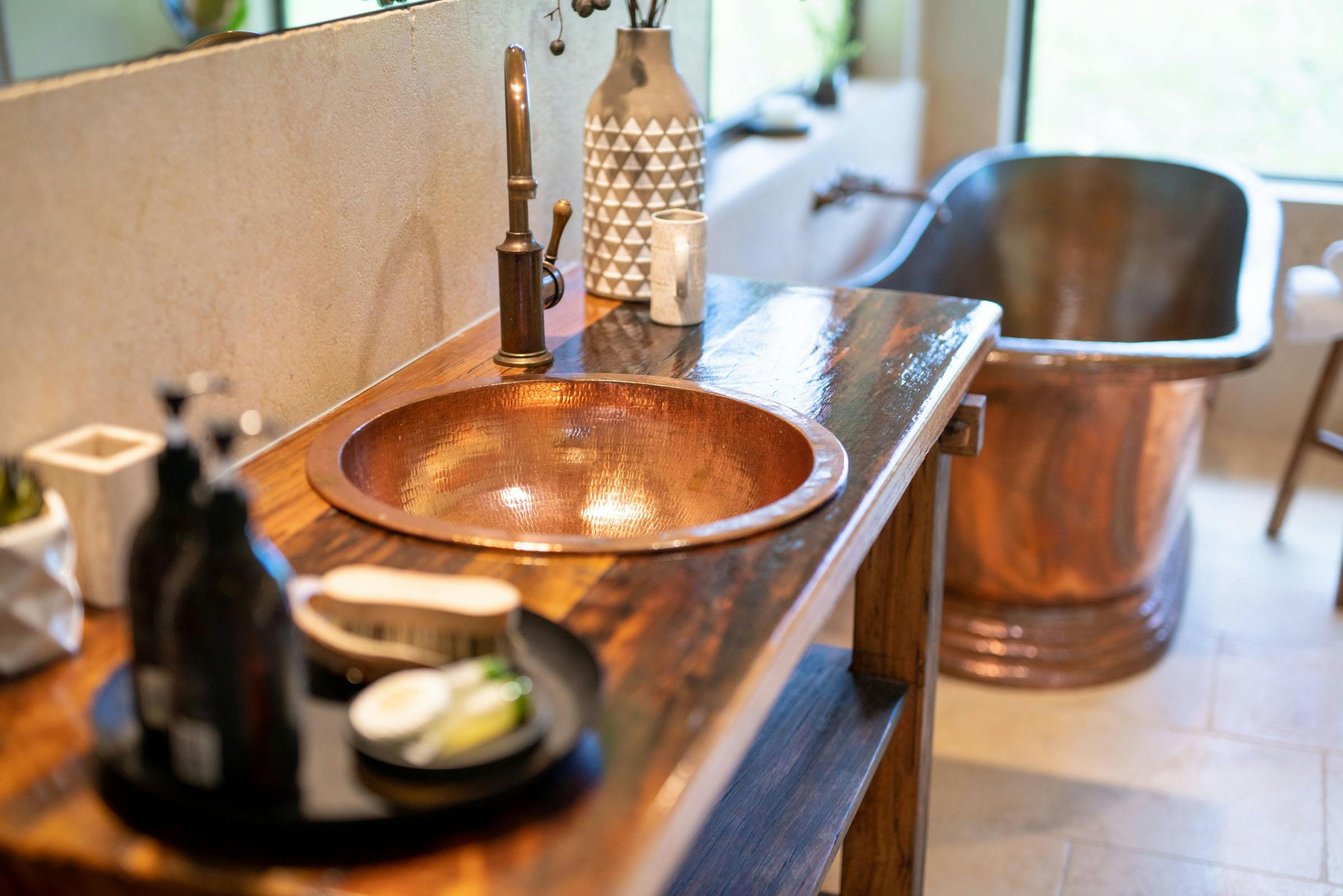 Deep copper bath with one way glass to relax and rejuvenate in