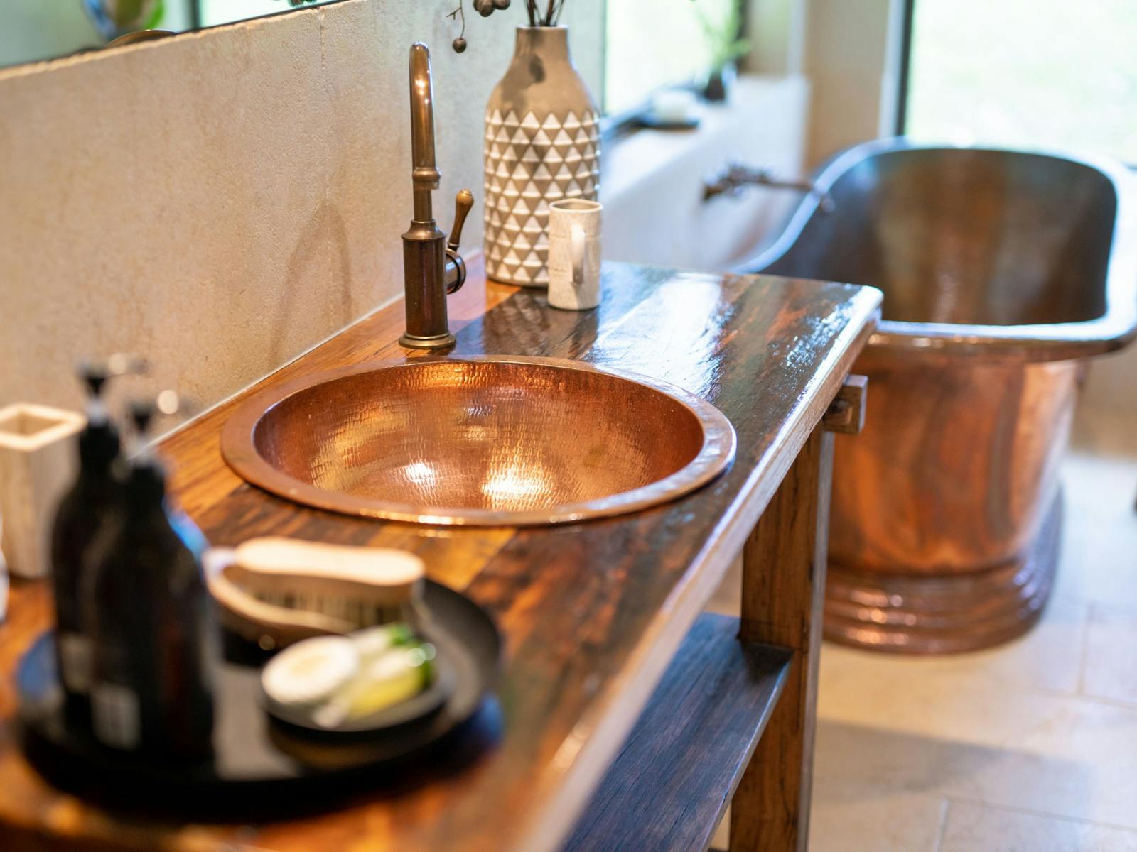 Deep copper bath with one way glass to relax and rejuvenate in