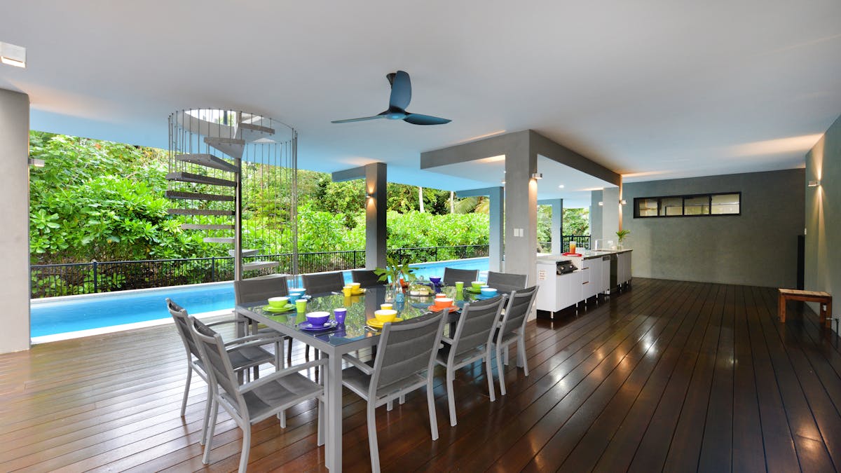 The poolside al fresco dining area includes a BBQ and pool bar.