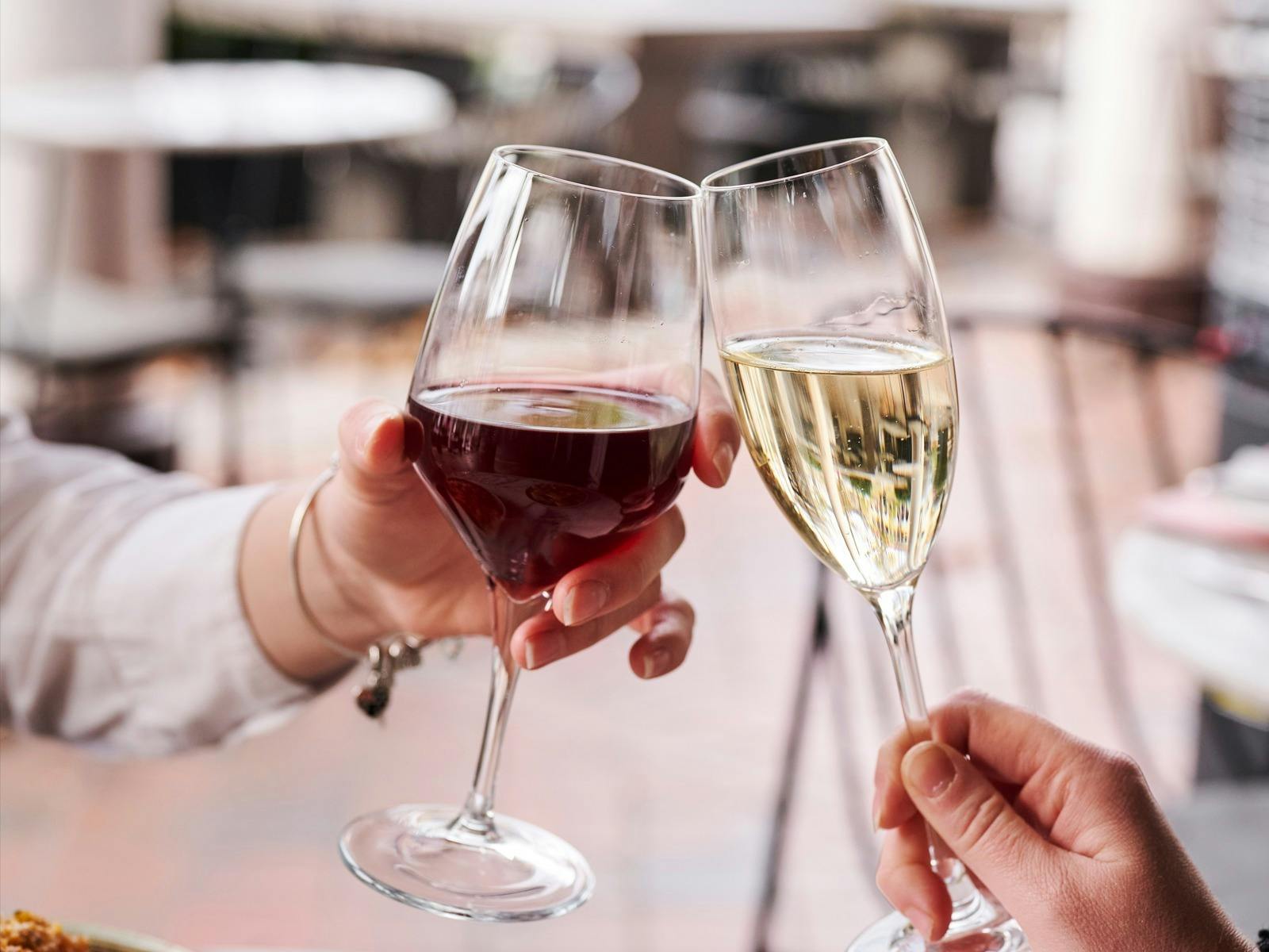 Clinking red wine and sparkling