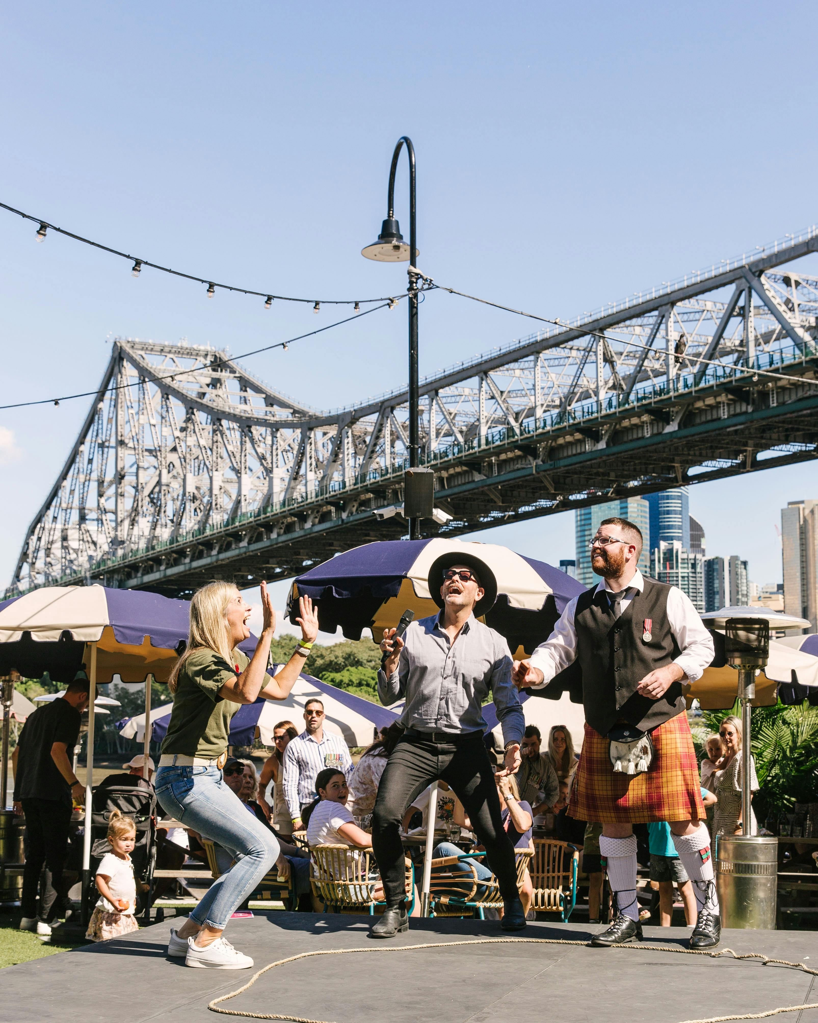 Two up being played with a view of the Story Bridge