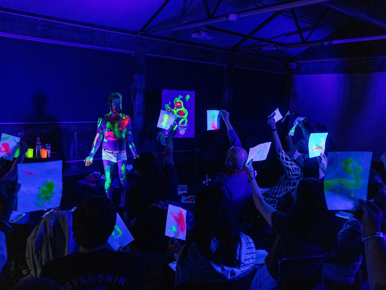 Main covered in UV body paint on stage