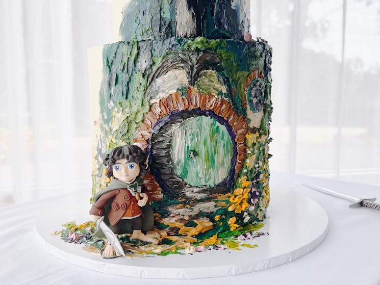 Base of a hobbit themed wedding cake, hand painted