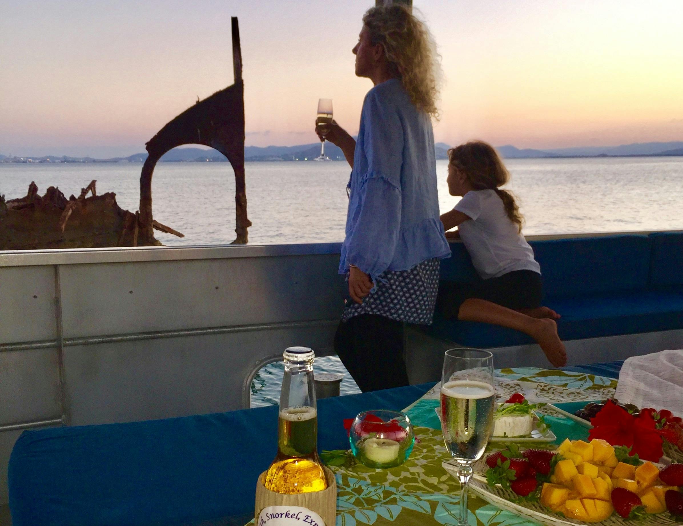 guests enjoying the sunset on the boat as Aquascene boat shows them the shipwreck