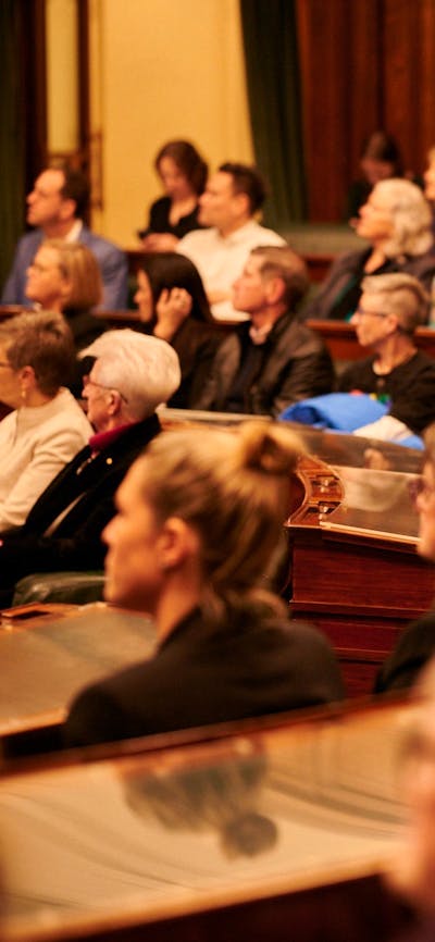 A group of people in the House of Representative chambers