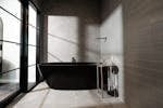 Experience relaxation at its finest, this bedroom boasts modern design with a freestanding bath.