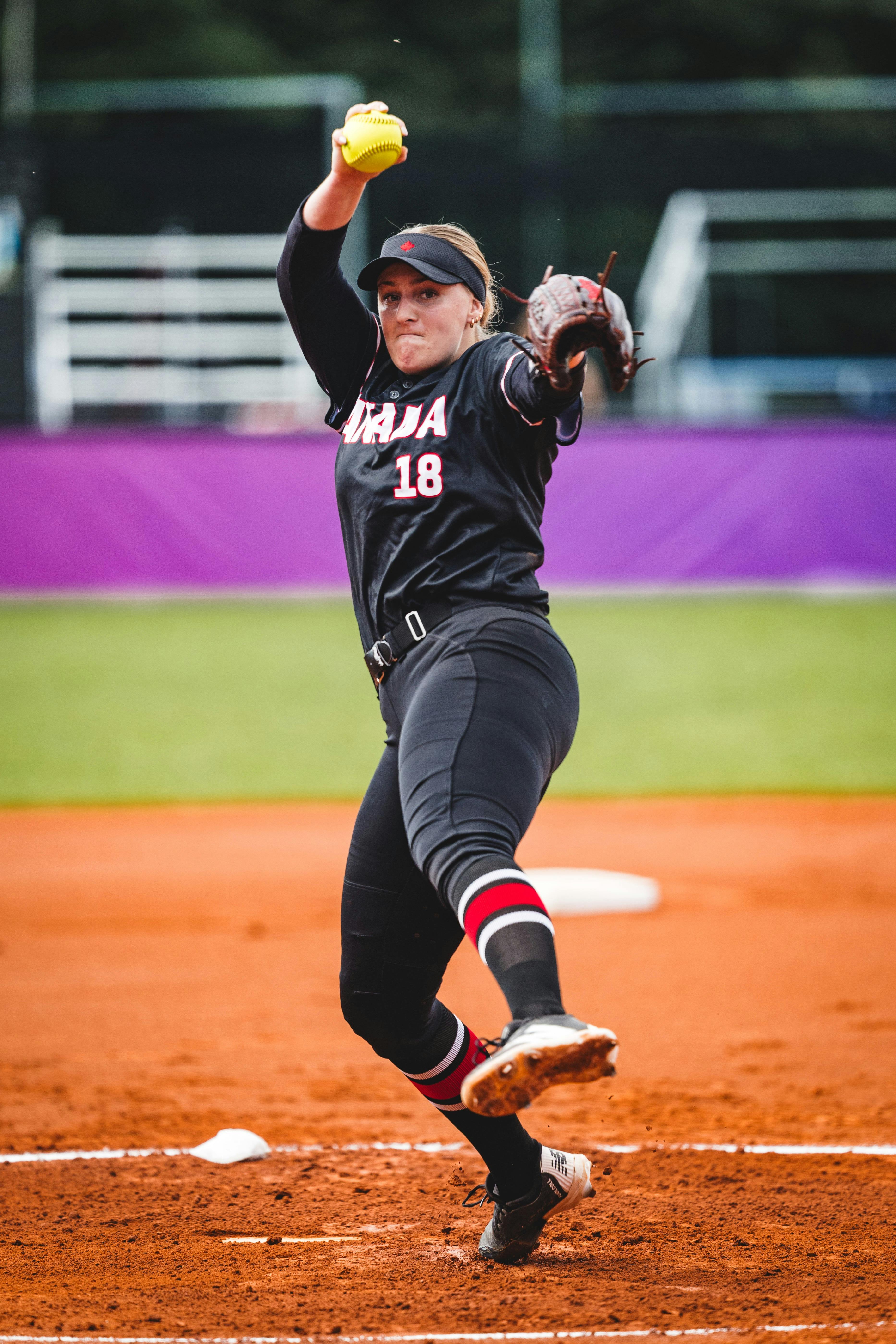 Canadian pitcher delivers a pitch during an international softball competition.