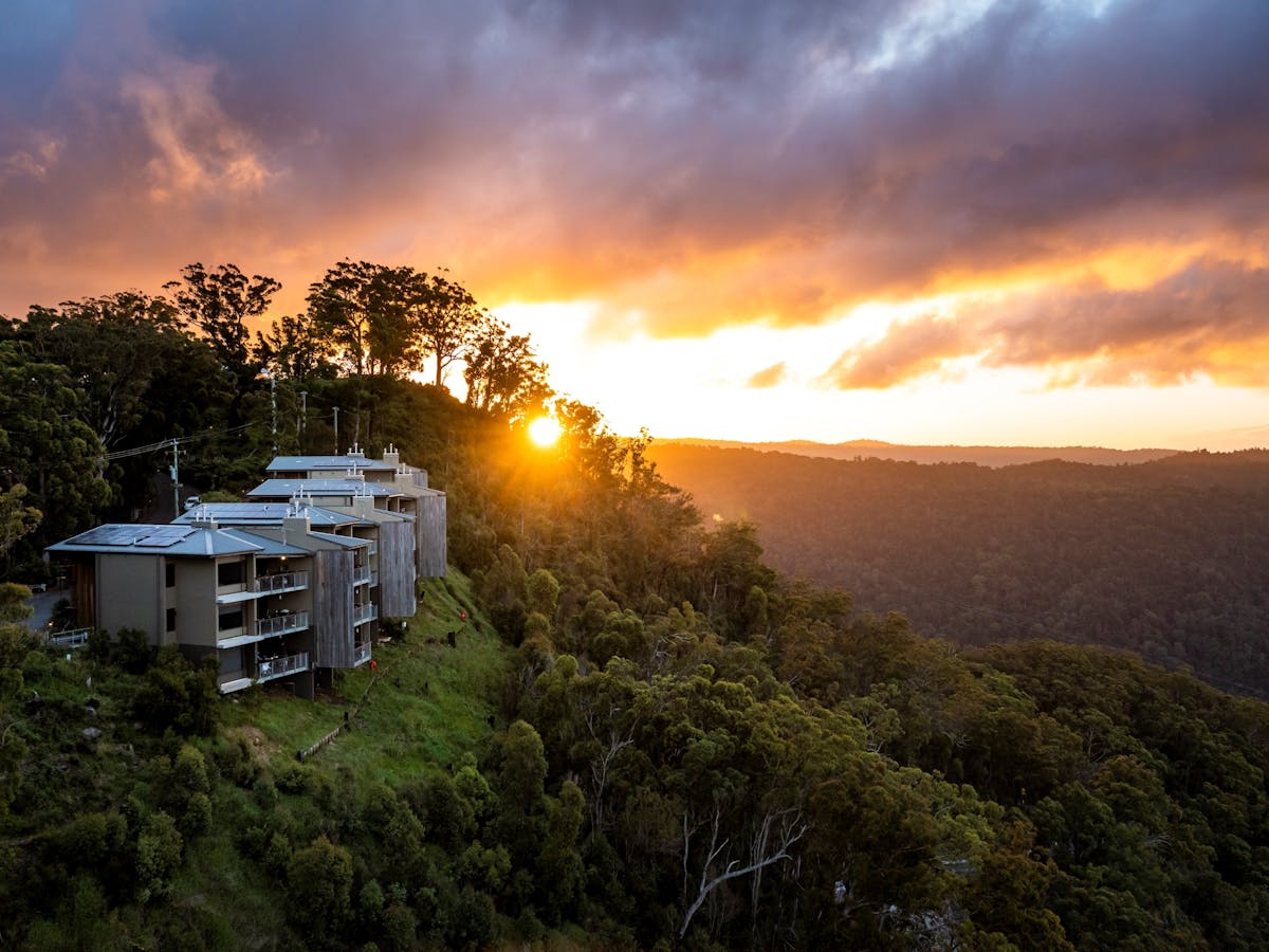 Accommodation on a hillside at sunset