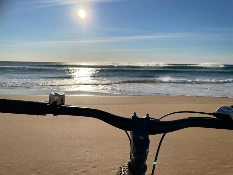Looking at Culburra Beach over the handlebars of a fat bike.