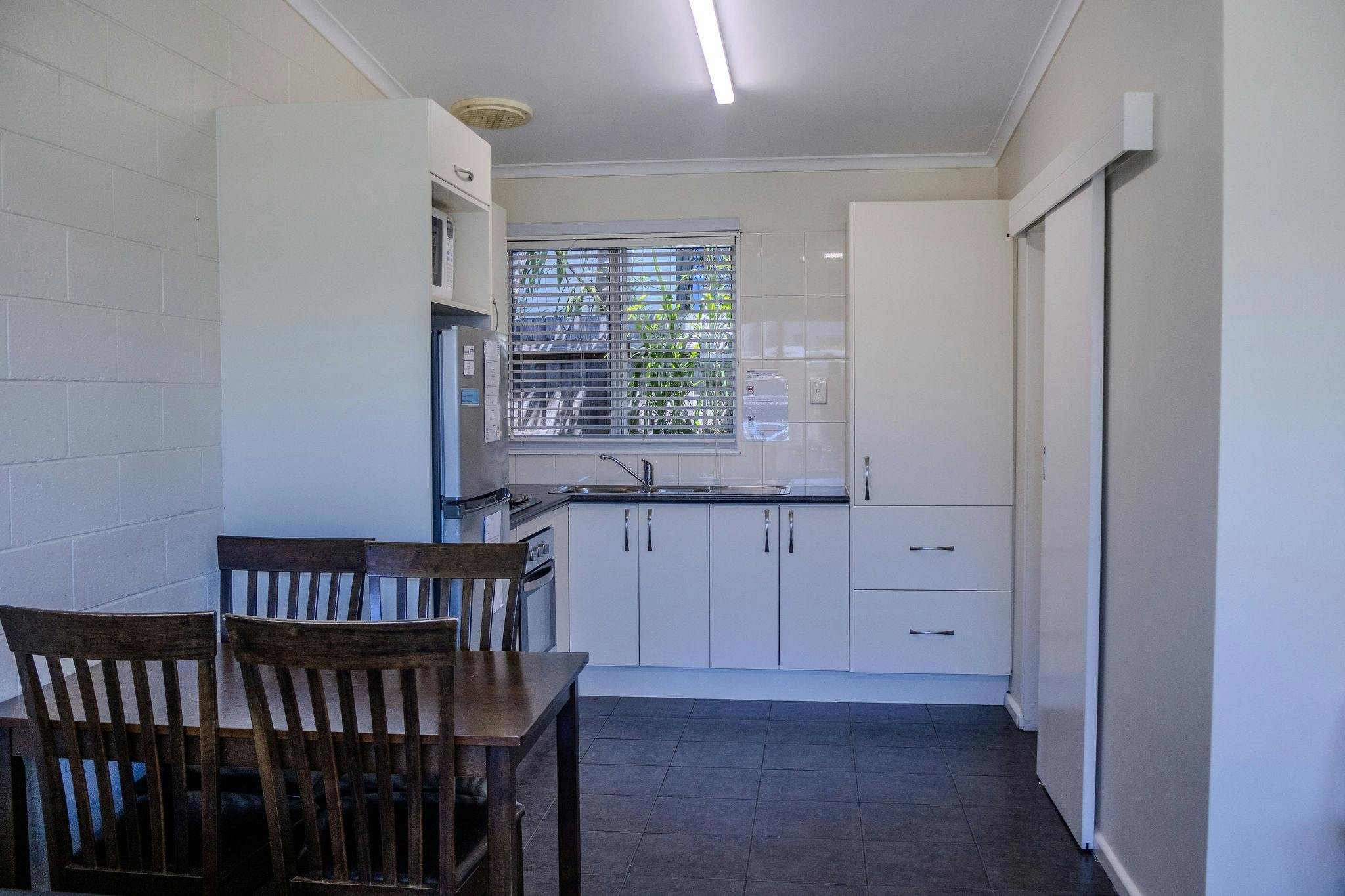 Full kitchen and dining area in a Silver Bream Motel self-contained unit