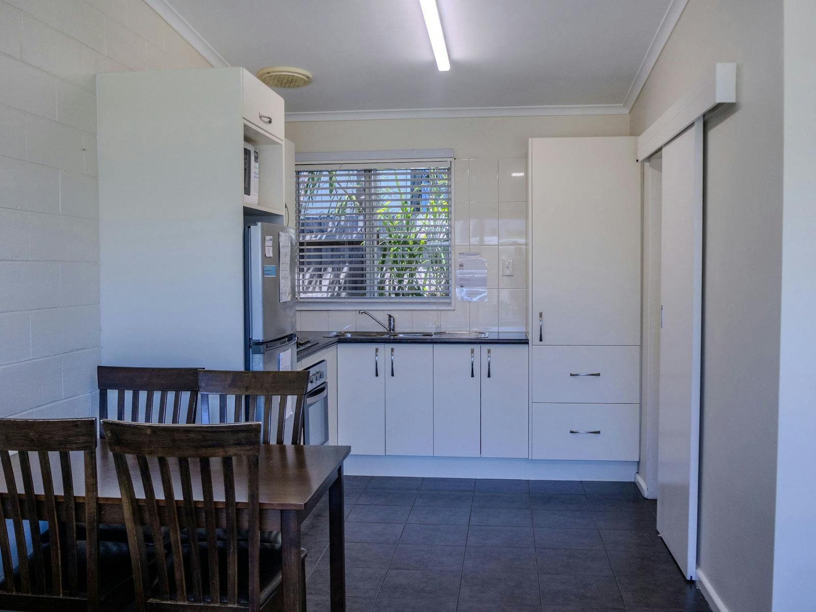 Full kitchen and dining area in a Silver Bream Motel self-contained unit