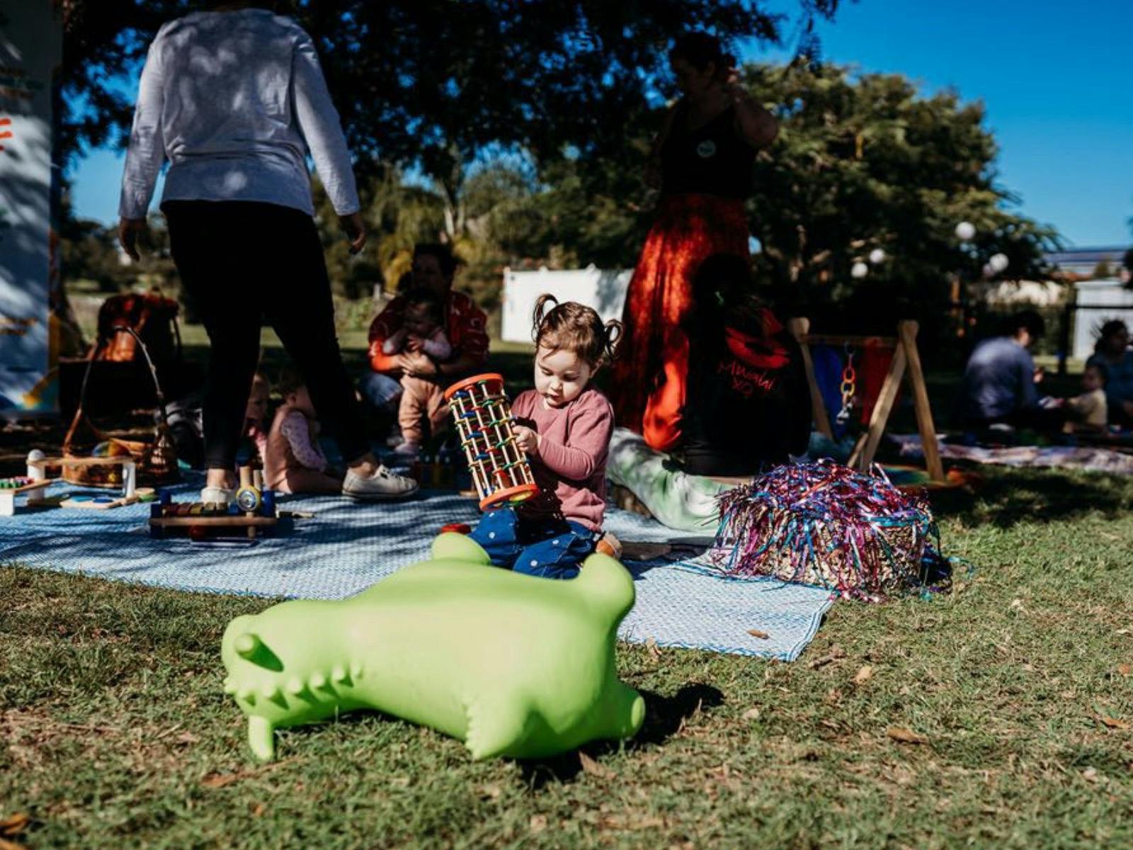 Toy bounce dragon with girl playing in background Toy bounce dragon with girl playing in background