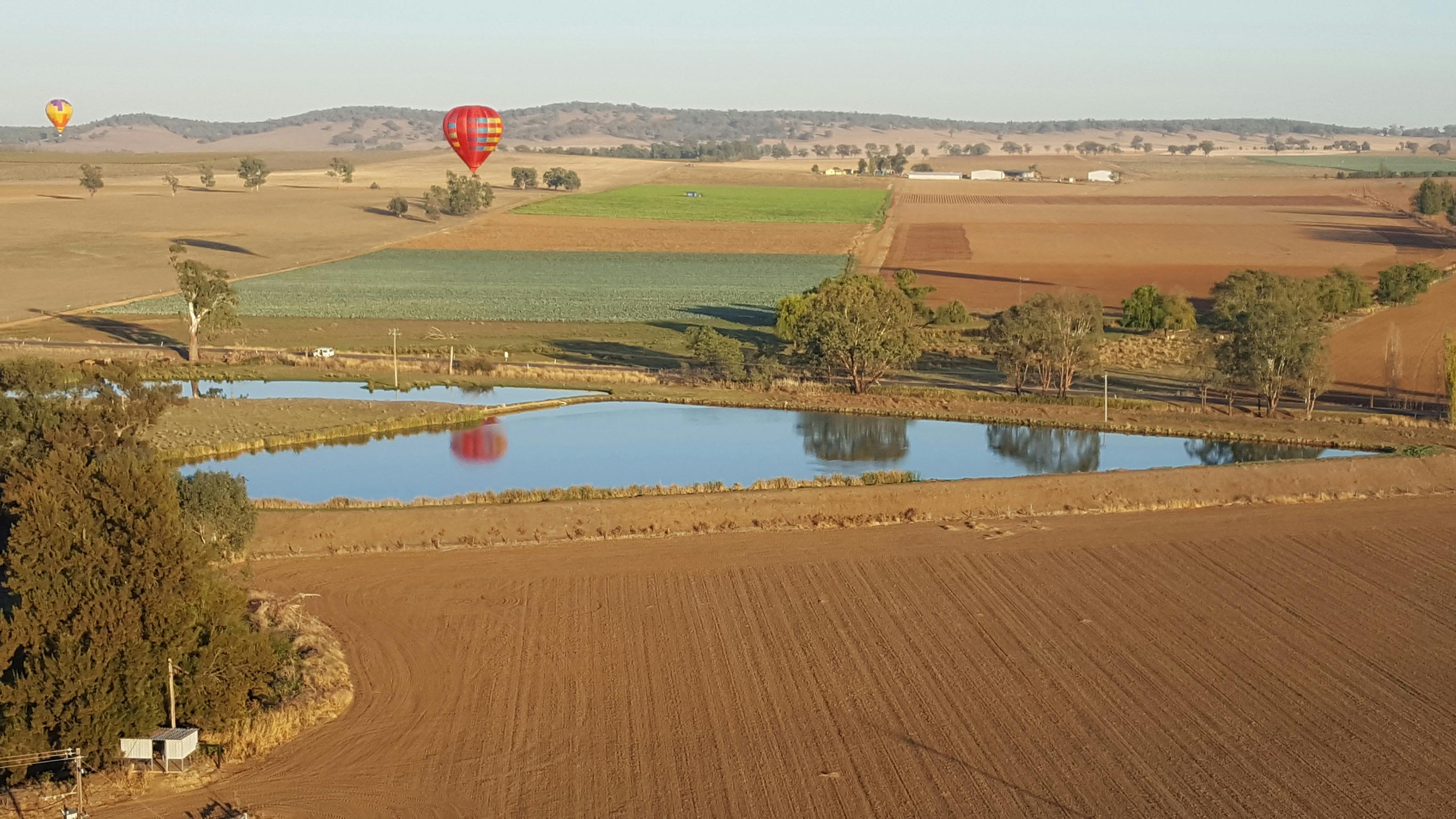 Balloon reflections over a dam