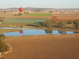 Balloon reflections over a dam