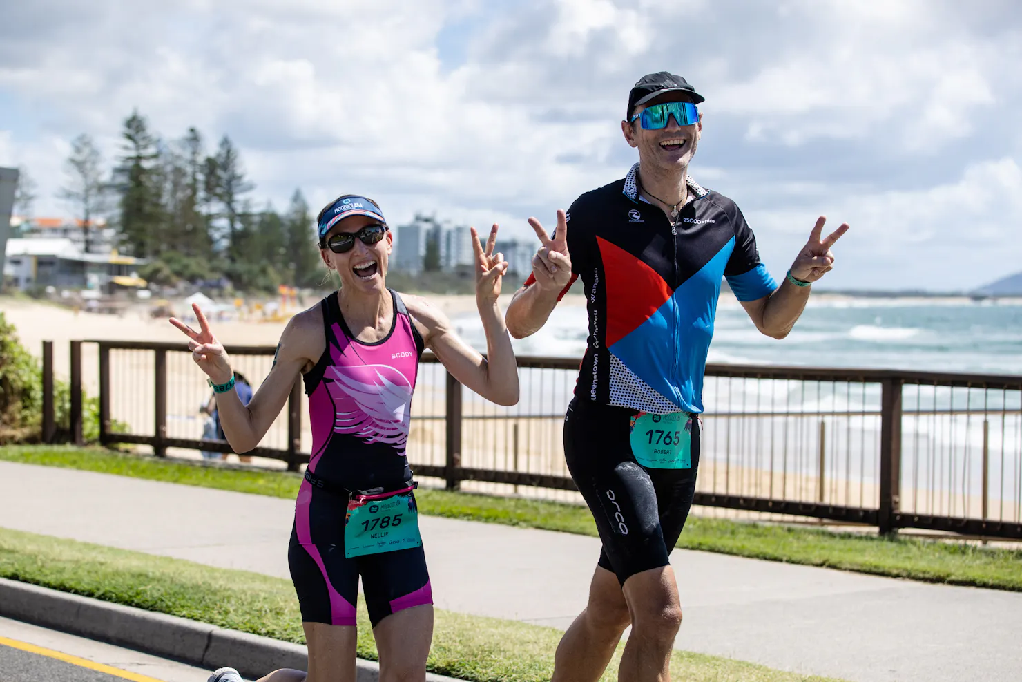 Happy runners with peace signs